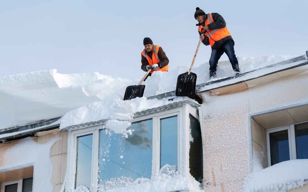 Removing snow from roof | Valley Restoration and Construction