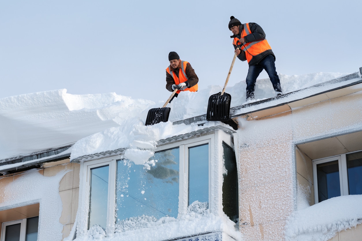 Removing snow from roof | Valley Restoration and Construction